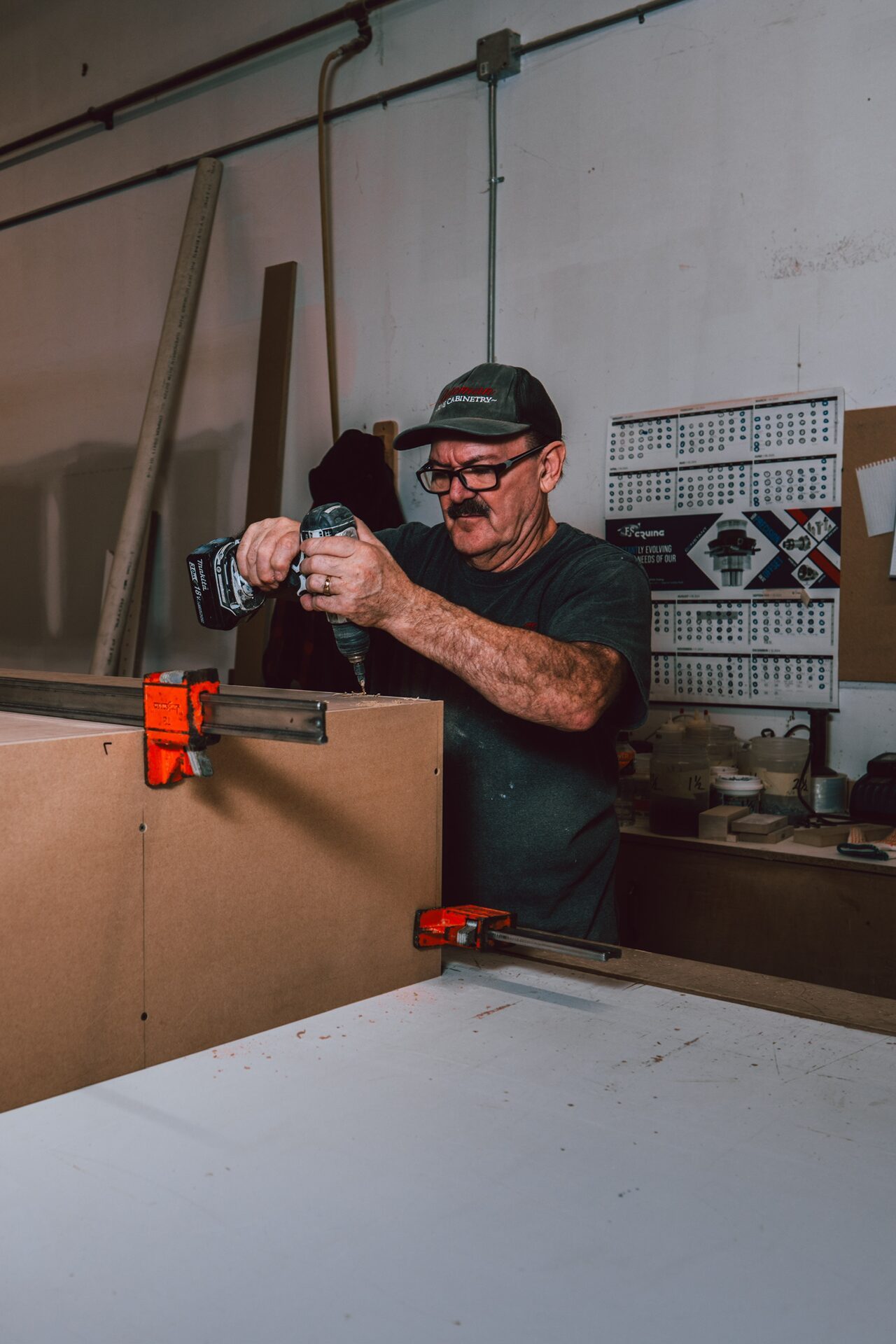 Craftsman assembling cabinetry in the Bateman workshop
