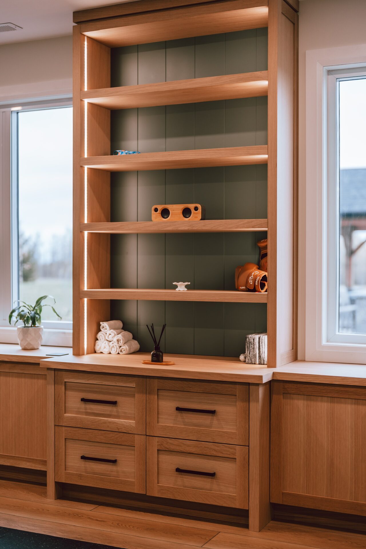 Custom oak built-in shelving with illuminated display