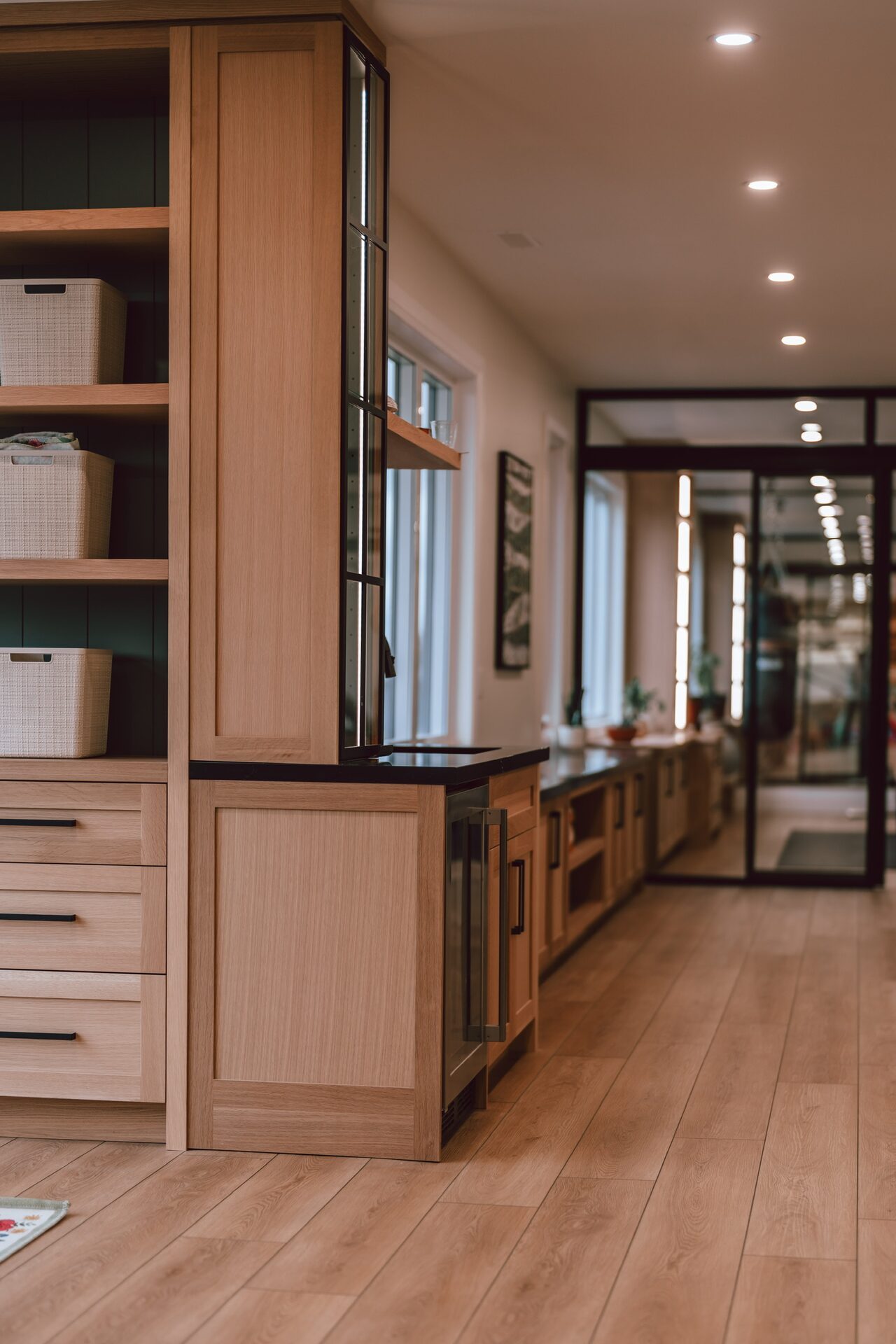 Butler's pantry with glass door cabinetry and wine fridge